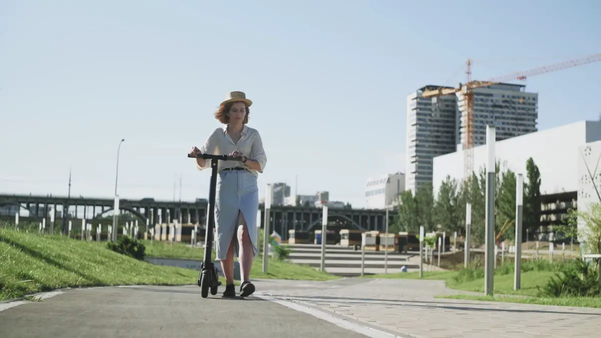 woman walking with her kick scooter